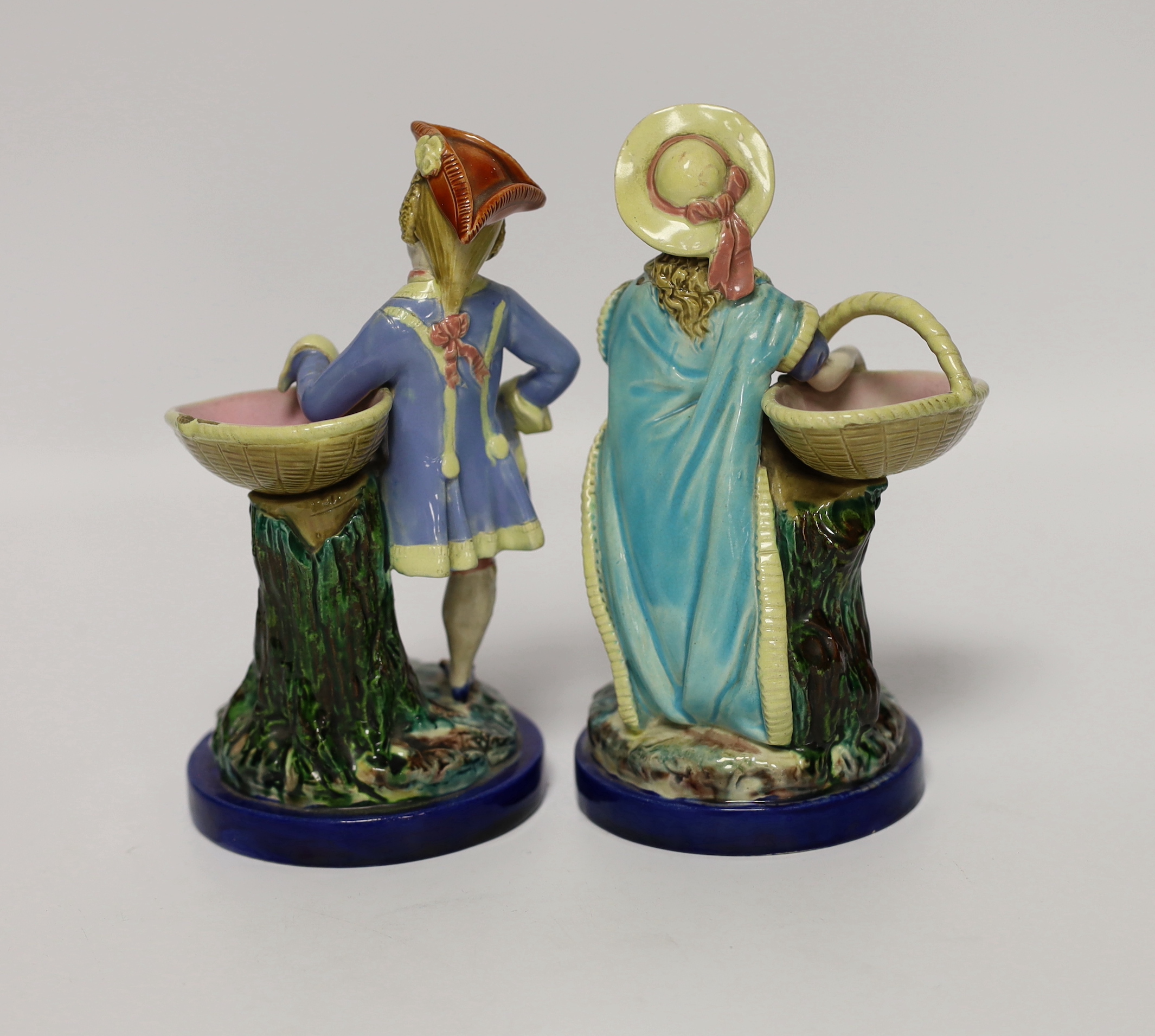 A pair of 19th century Worcester majolica figures holding baskets, largest 17cm high